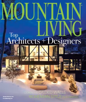 Modern house in snowy mountain landscape at dusk.