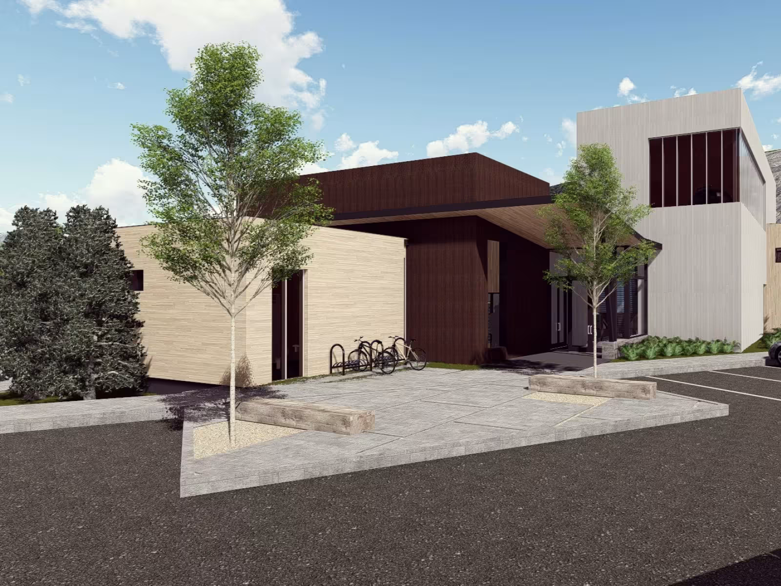 Modern building with trees, parked car, and mountain backdrop.