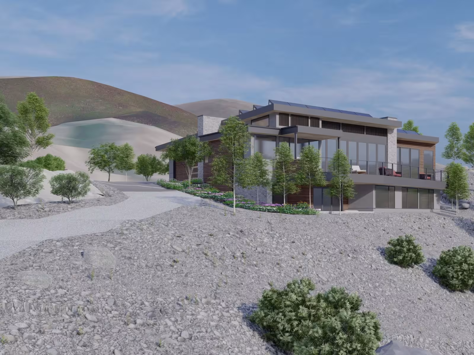 Modern house on a rocky hill with trees under a clear blue sky.