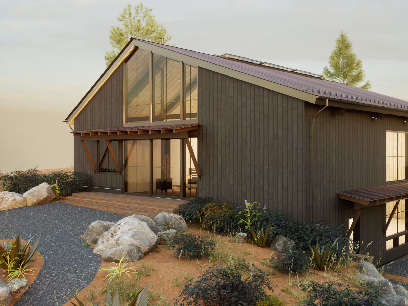 Modern barn-style house with large windows in a desert landscape.